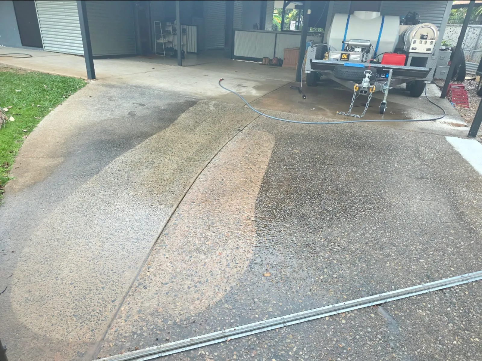 Dirty exposed-aggregate driveway during an initial cleaning test