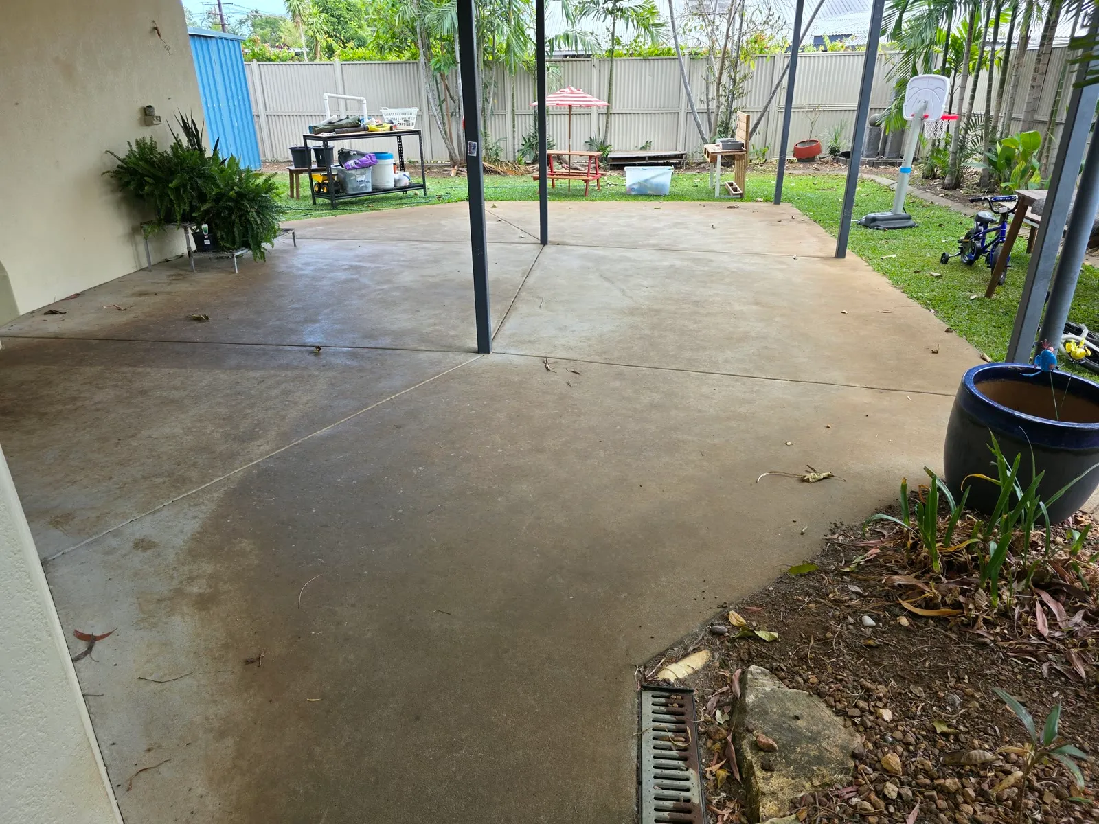 Weathered concrete patio before pressure cleaning