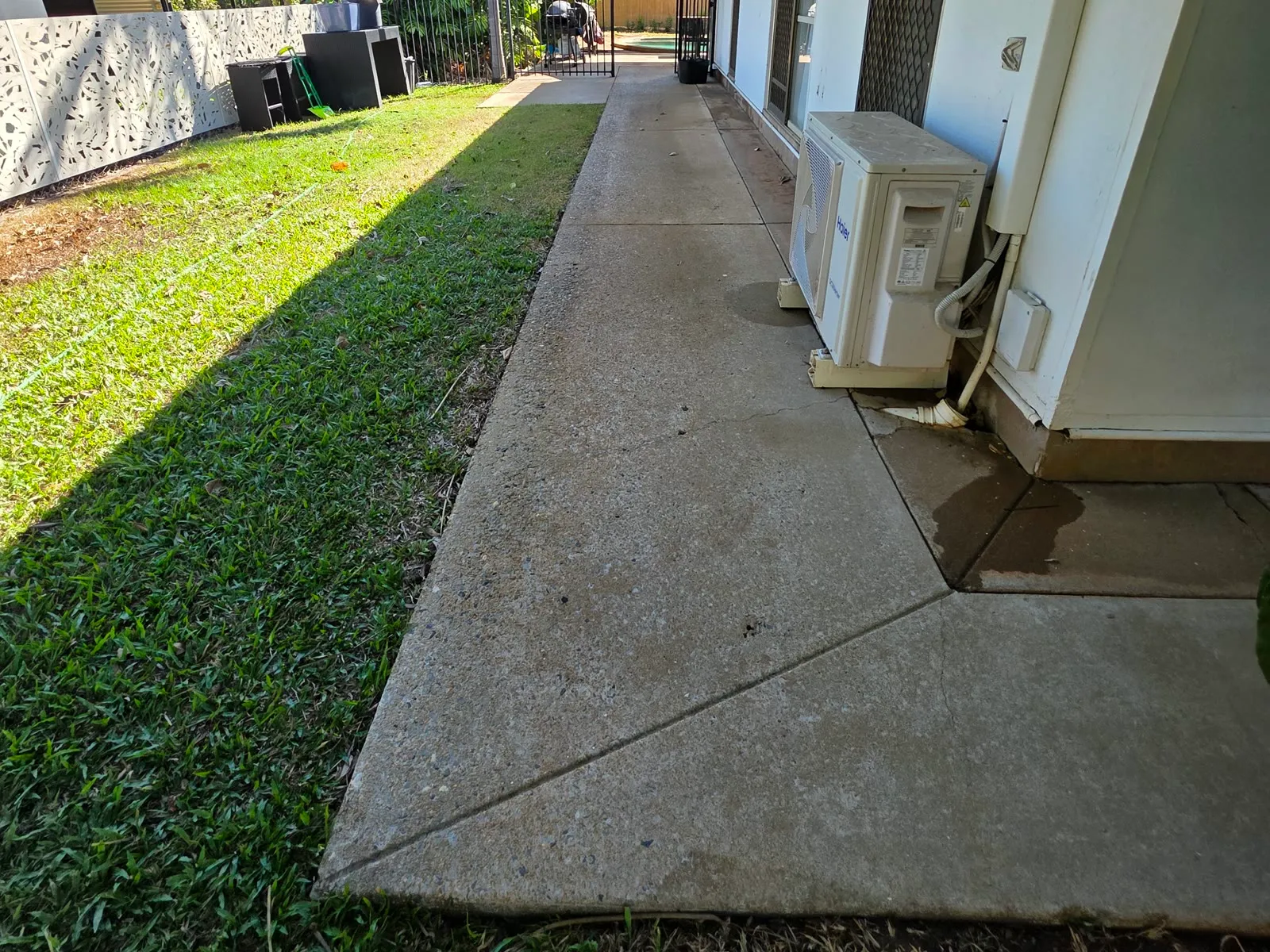 Brighter concrete path after pressure cleaning